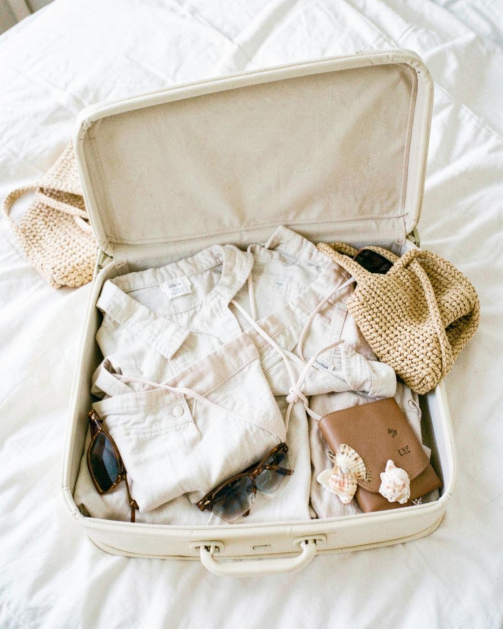 Honeymoon packing laid out with resort pieces and travel documents