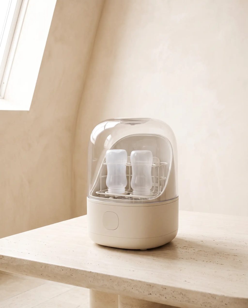 Editorial inspiration: a cream countertop bottle washer and steriliser holding baby bottles