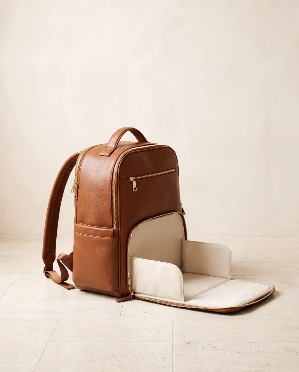 Editorial inspiration: a tan leather diaper backpack with fold-out changing mat