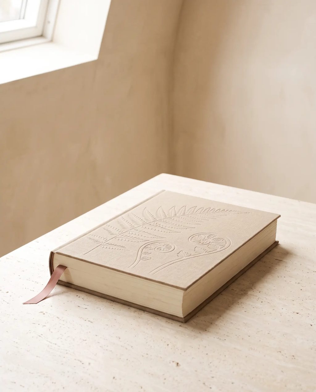 Editorial inspiration: a linen-bound pregnancy journal with embossed cover and ribbon
