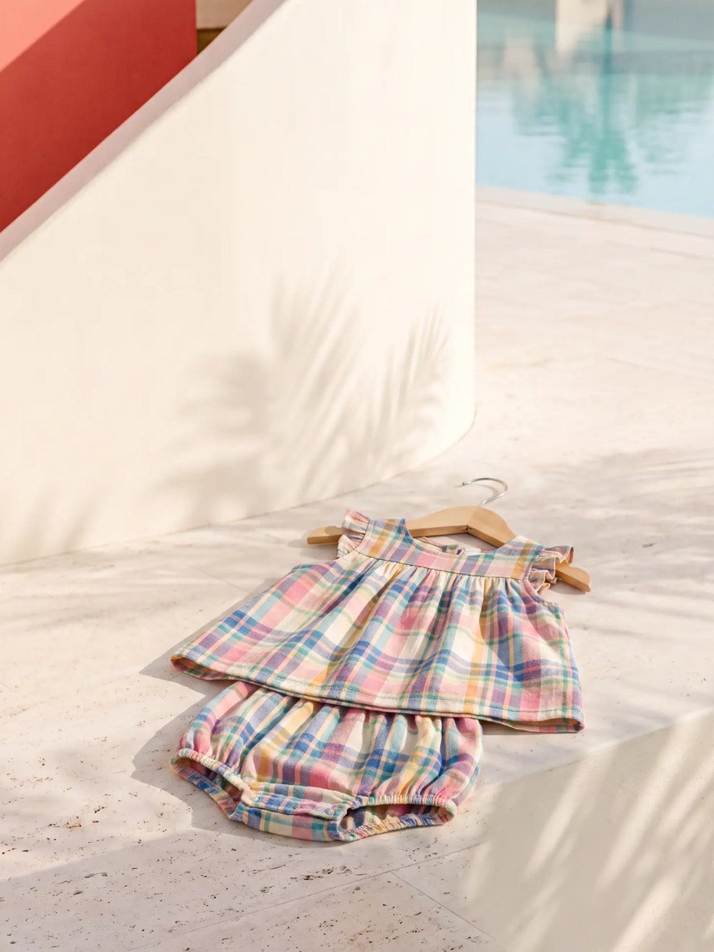Editorial inspiration for a rainbow plaid baby top and bloomer set
