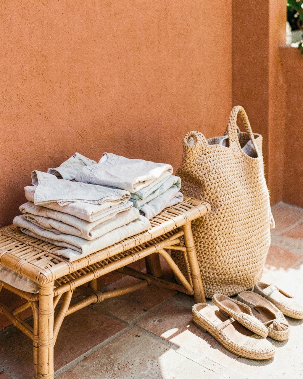 Resort packing with swimwear, straw bag and light layers